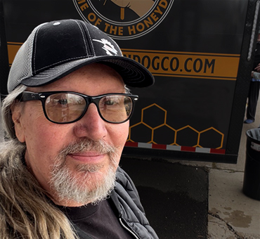 photo stevie, the food trucks guy, in front of a vendor location